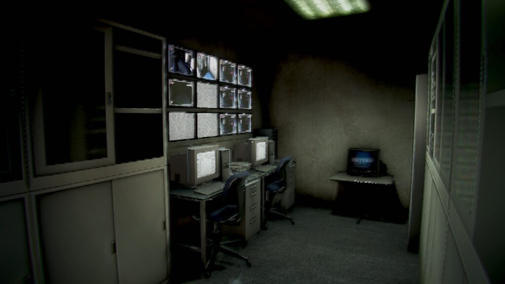 A security room illuminated by camera monitors