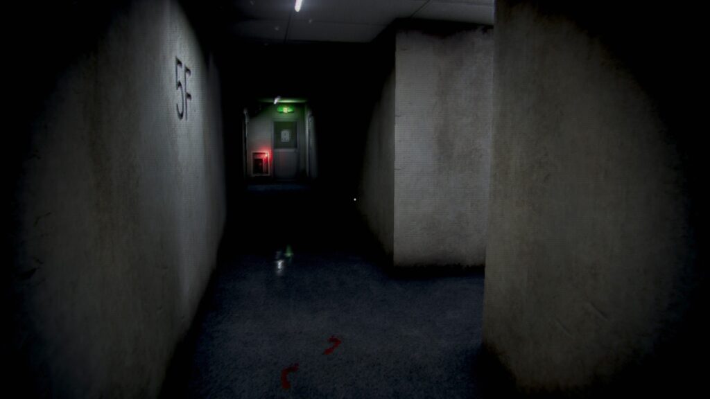 A dark hallways leads to an exit door