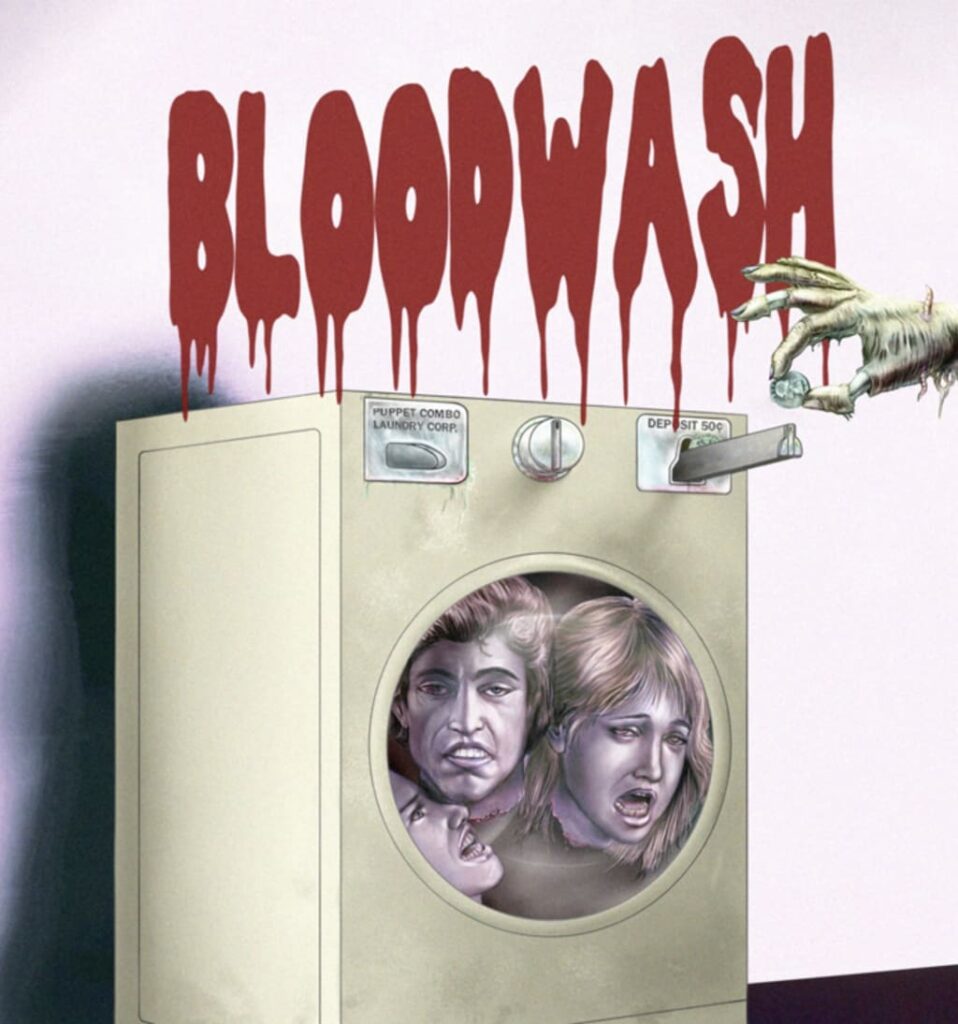 Two screaming faces look out of a washingmachine door. A zombie-like hand is putting a coin in the machine. Red text above reads "Blood Wash"