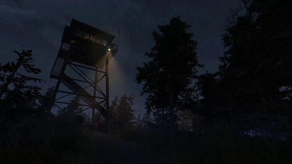 A lookout tower shines a light on a dark forest