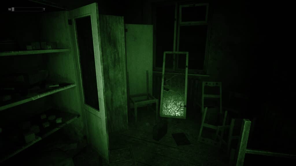 A night vision camera shows a room full of destroyed furniture. 